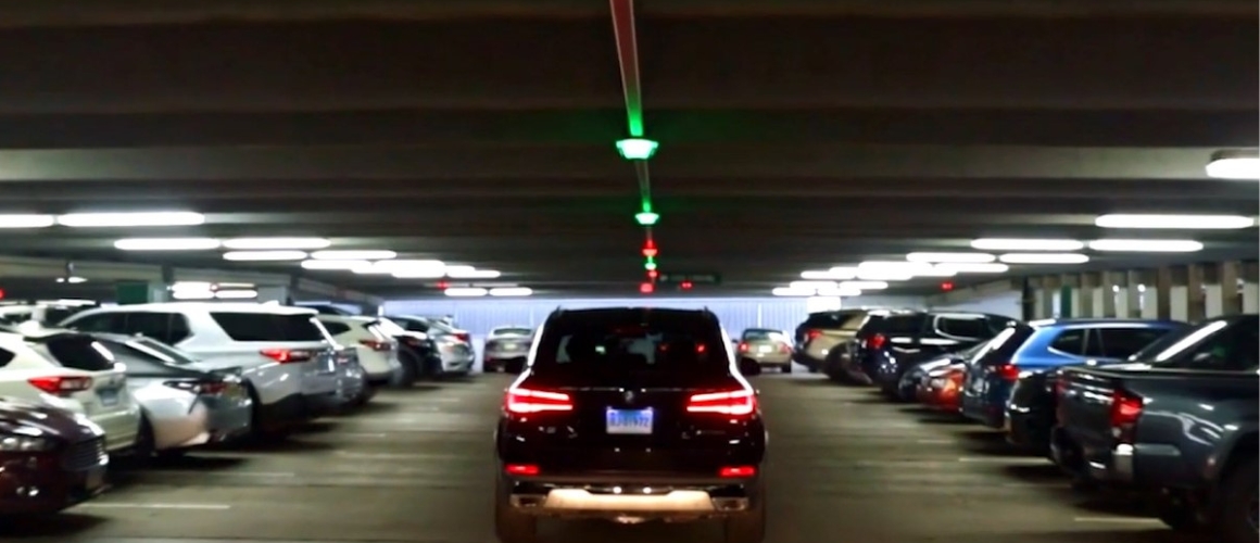 City garage in Naples, FL with M5 park assist sensors above vehicle in driving lane.