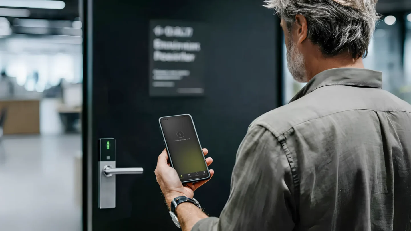 Man using a smartphone to unlock a door with access control from TKH Security