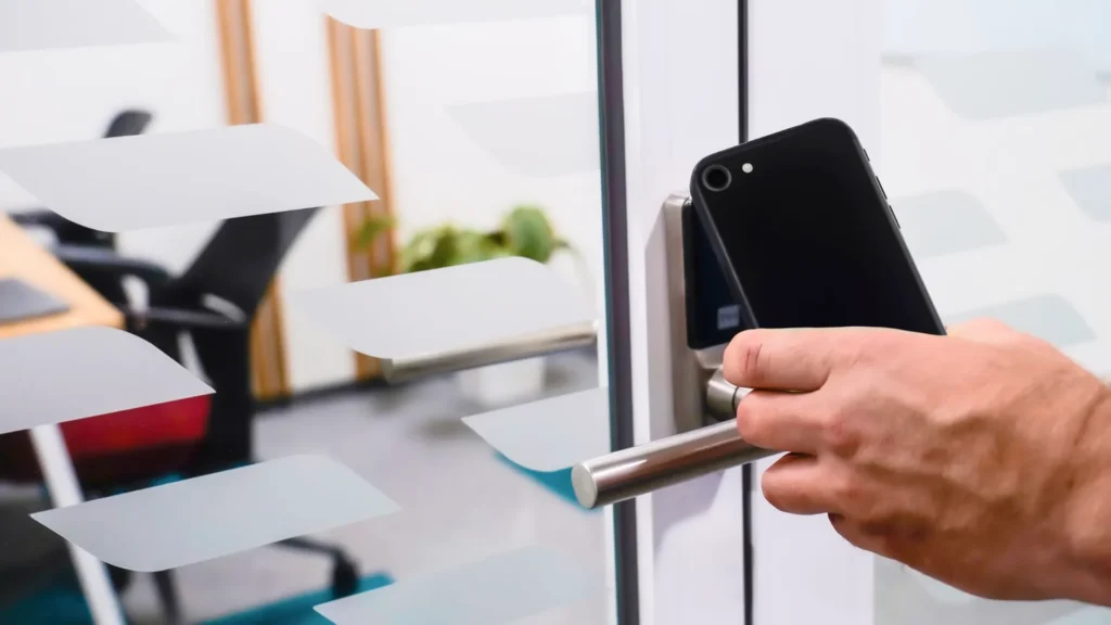Person using a smartphone to unlock a door with an access control reader