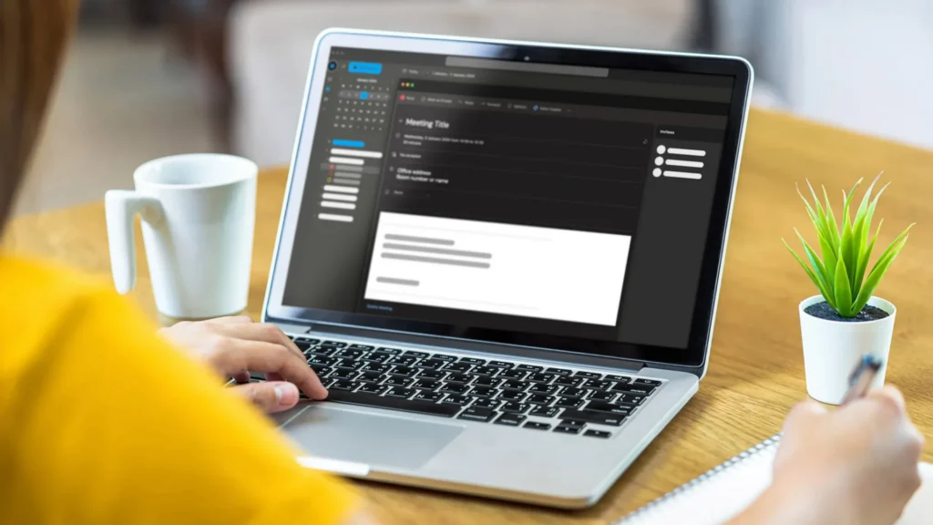 Person using a laptop with email ATLAS interface for visitor access management
