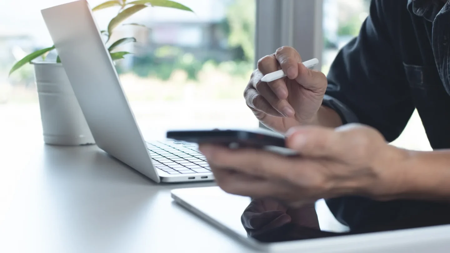 Person using a laptop and mobile to access ATLAS manuals