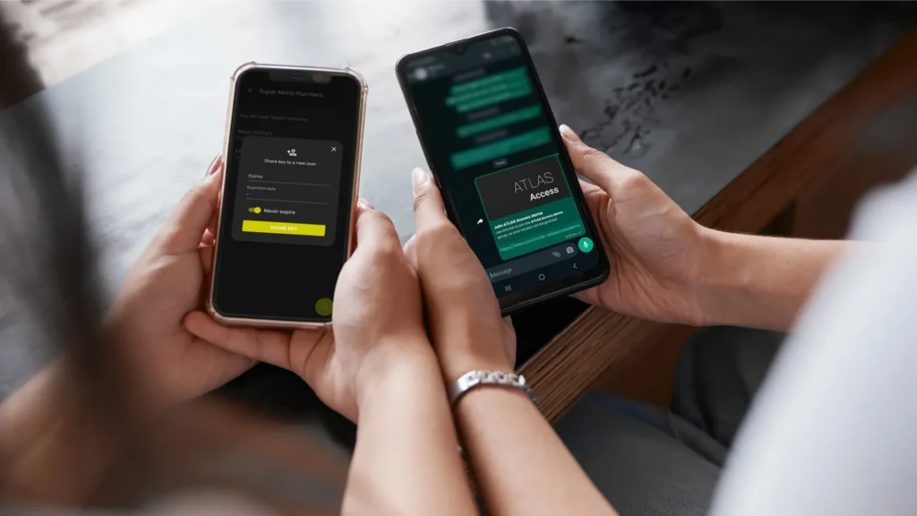 Two people using mobiles to manage key sharing in a retail environment