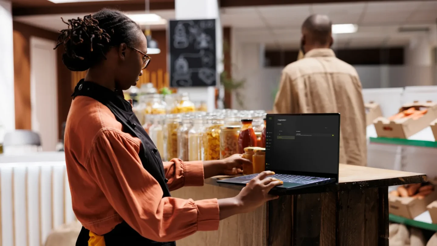 Store manager using ATLAS with a tablet at a retail counter to manage operations