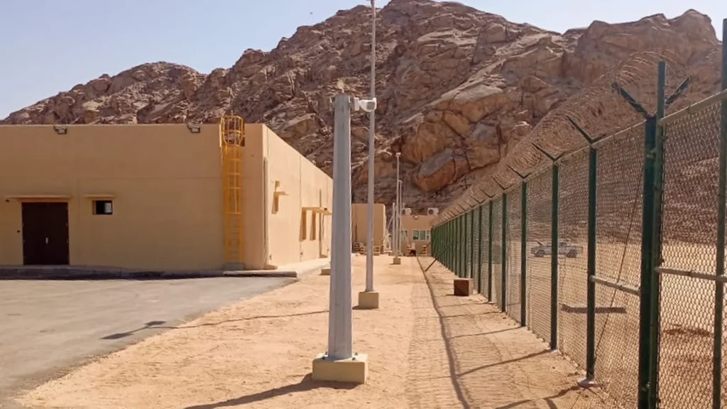 Perimeter fence in a remote desert facility achieving optimal surveillance in complex environments
