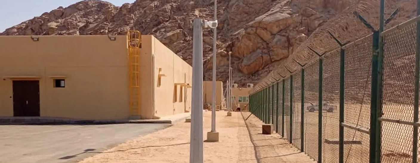 Perimeter fence in a remote desert facility achieving optimal surveillance in complex environments