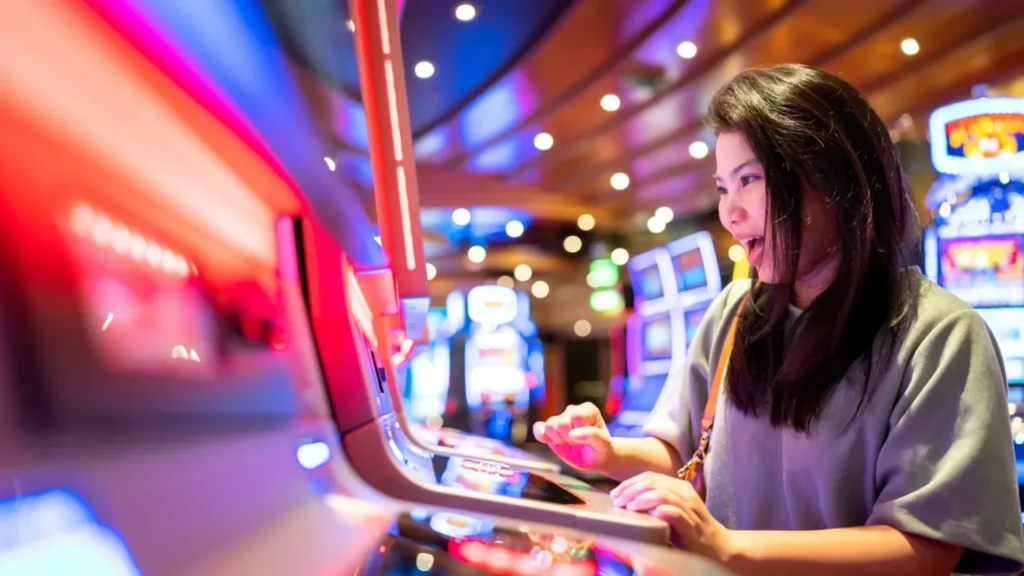 Woman playing a digital casino game inside a gaming floor environment