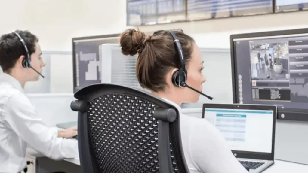 Operators sitting infront of FLINQ security management system screens monitoring reduced customer wait times, increased service coverage.