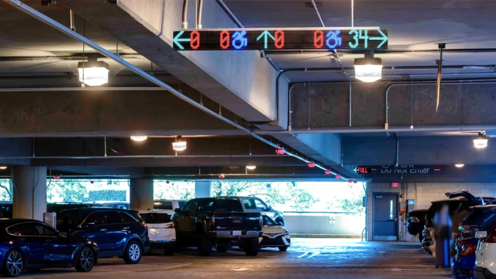 Parking garage with M5 sensors and a VMS sign showing availability including ADA and directional counts