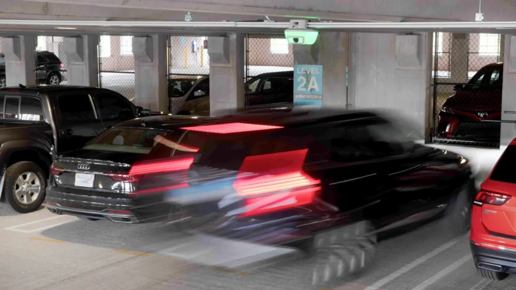 Car parking under green M5 sensor indicating open space in airport parking garage