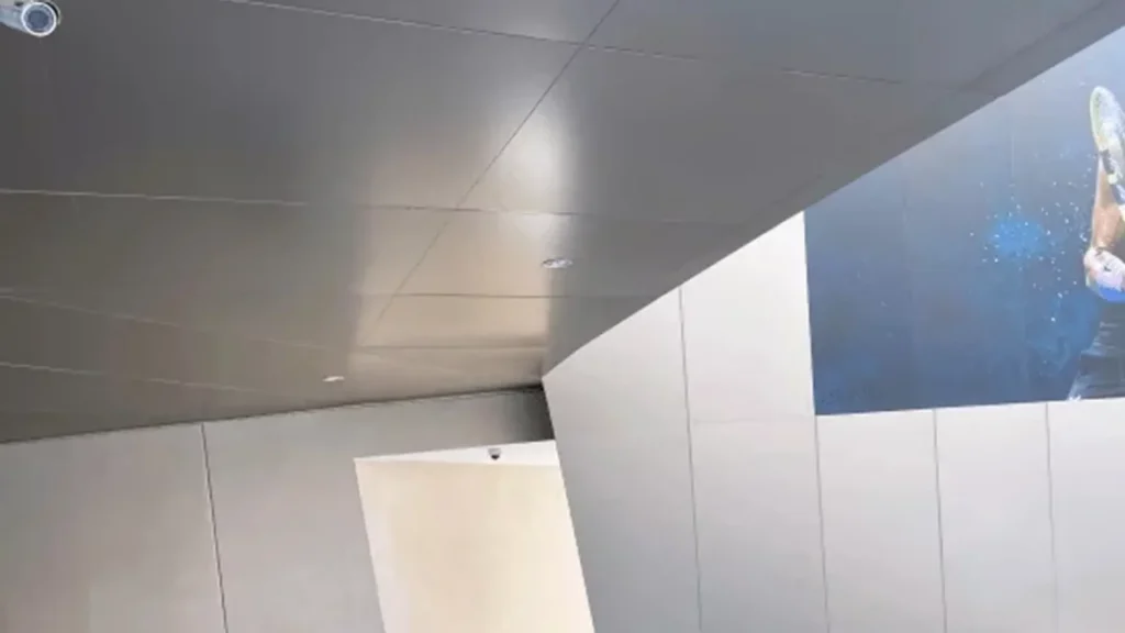 Ceiling-mounted surveillance camera inside Tamdeen Group building