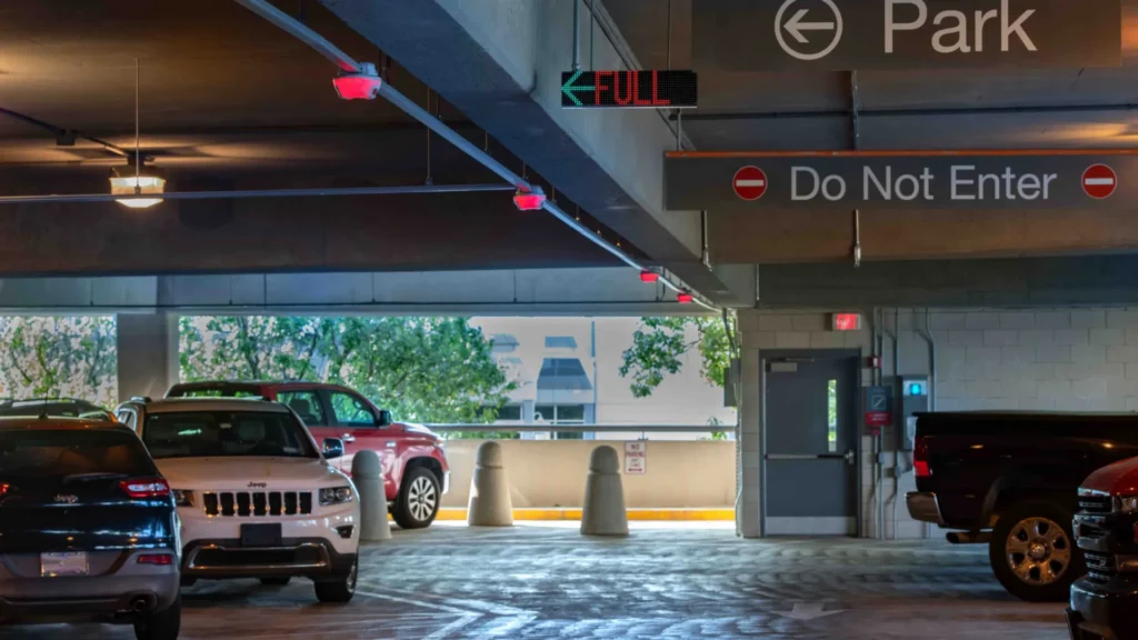 Cars parked in a garage under red cameras based M5 smart sensors