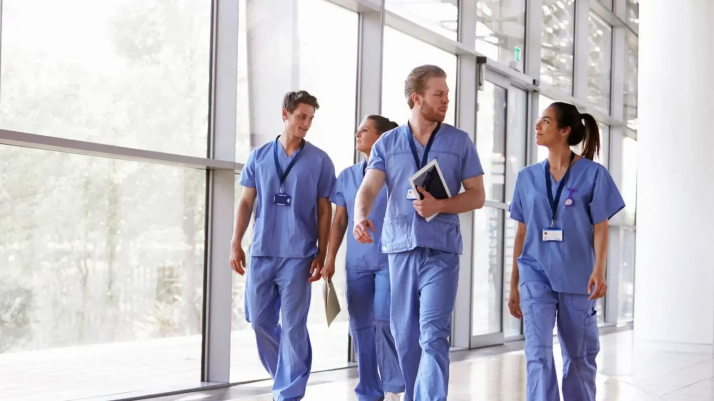 Healthcare professionals walking together in a hospital corridor