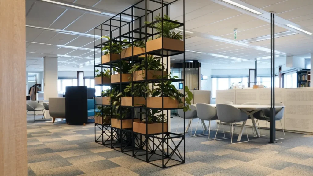 IPROTECT supporting modern open-plan office space with desks, chairs, and indoor plants