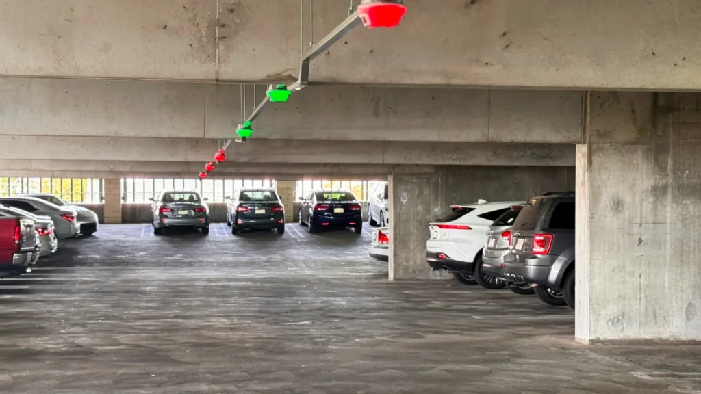 Parking garage with red and green M5 smart sensors indicating occupied and available spaces