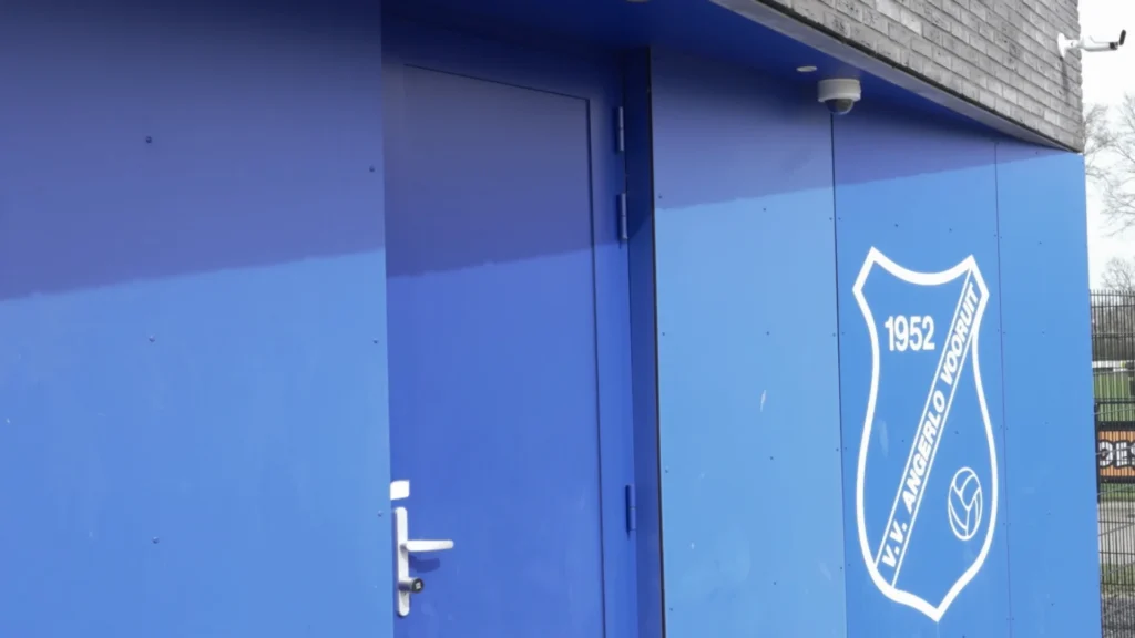 Blue entrance door at Angerlo Vooruit Football Club, marked with the club's 1952 crest.